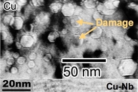 When copper is irradiated, defects form in the metal lattice (top photo). In a nanocomposite of copper and niobium, radiation damage is contained by interfaces between the copper and niobium layers (bottom photo).