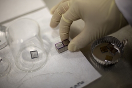 A pair of mini ion thrusters, including their propellant tanks, is prepared for tests.