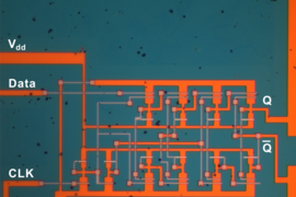 An optical-microscope image shows a complex integrated circuit, called a JK flip-flop circuit, a basic logic device, made on a piece of molybdenum disulfide by the MIT team.