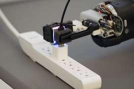 Armed with the GelSight sensor, a robot can grasp a freely hanging USB cable and plug it into a USB port.