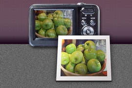 Photo of green apples, in front of a camera with viewfinder showing green apples