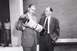 A 1957 photograph shows President James R. Killian Jr. (left) and professor of electrical engineering Harold “Doc” Edgerton burying the time capsule. 