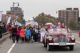 MIT's "Crossing the Charles" procession and competition was a featured part of the Institute's Moving Day festivities, May 7, 2016. Here, grand marshall Oliver Smoot '62 (right) rides at the front of the parade.