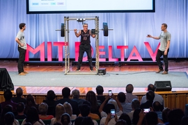 Bill Aulet, managing director for the Martin Trust Center for MIT Entrepreneurship, tests out the prototype from Perch, which is developing a video-tracking system for weight lifters. Flanking Aulet are Perch co-founders Nate Rodman (left) and Jacob Rothman.