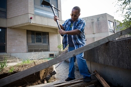 At the John M. Tobin Montessori School in Cambridge, volunteers spent a chilly morning and afternoon working outside for CitySprouts, a program that plants gardens at elementary schools and creates curricula around agriculture, food, and the environment. Pictured, Kariuki Thande, a financial officer in the Department of Physics, cuts a wooden beam that will be used as part of a new border for the ...