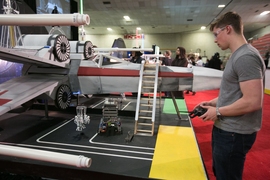 A student competes in the 2017 MIT Mechanical Engineering 2.007 Student Design Final Robot Competition.