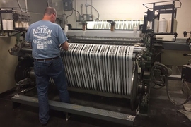 Marty Ellis, of Inman Mills in South Carolina, checks a machine manufacturing fabric developed through AFFOA.
