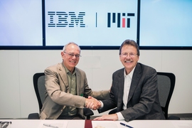 MIT President L. Rafael Reif, left, and John Kelly III, IBM senior vice president, Cognitive Solutions and Research, shake hands at the conclusion of a signing ceremony establishing the new MIT–IBM Watson AI Lab.
