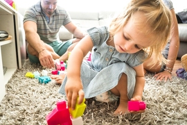 Researchers found that babies who watched an adult struggle to complete tasks before succeeding tried harder at their own difficult task, compared to babies who saw an adult succeed without effort.
