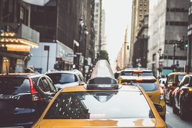 Rear view of yellow taxi in city traffic