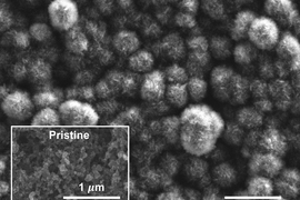 This scanning electron microscope image shows the carbon cathode of a carbon-dioxide-based battery made by MIT researchers, after the battery was discharged. It shows the buildup of carbon compounds on the surface, composed of carbonate material that could be derived from power plant emissions, compared to the original pristine surface (inset).