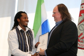 Ethan Zuckerman, head of the MIT Media Lab’s Center for Civic Media, and David Sengeh, PhD ’16, Sierra Leone’s Chief Innovation Officer, exchange a memorandum of understanding for collaborative work.