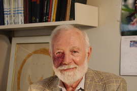 Photo of Isadore Singer sitting in his office