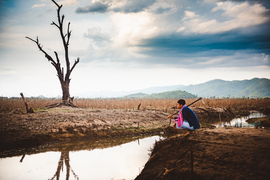 a boy looks out over baren land