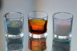 3 small glasses hold: left, aluminum; center, sulfur; and right, rock salt crystals.