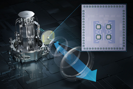 On left, a complex metallic lab refrigerator has an inset shows a chip. The chip is enlarged on the right and has 4 squares in the middle of the chip. An arrow represents receiving data.