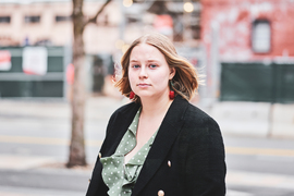 Mikayla Britsch stands outside with blurry background.